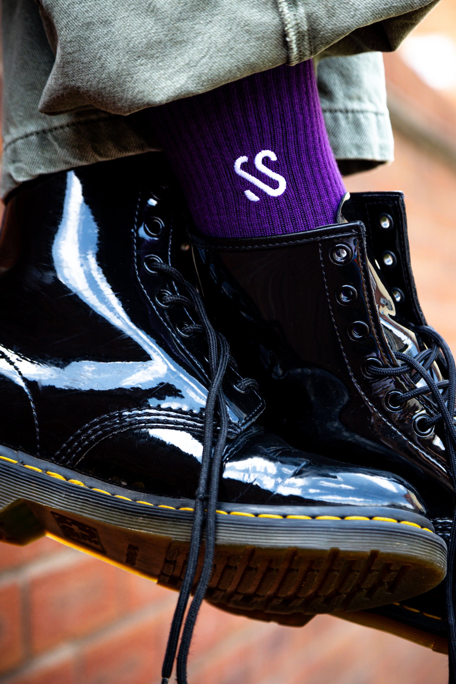 Social Socks Classic Plum Purple Being Worn On Feet With Black Boots